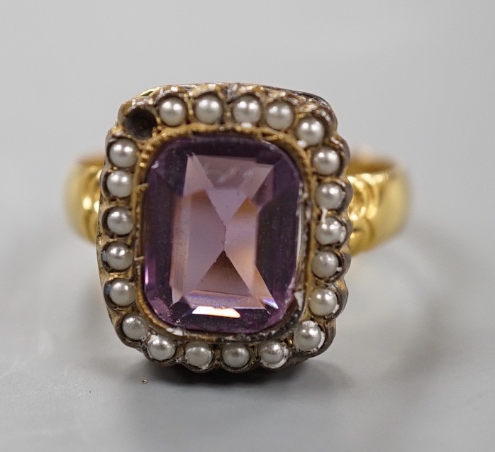 A Victorian 18ct gold, amethyst paste and simulated split pearl cluster set dress ring, size M, gross weight 4.5 grams.